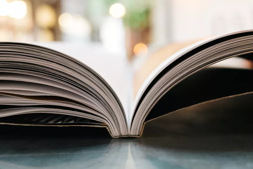 An open book on a table. Photo.